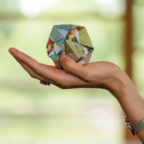 Hand Holding a Glowing Gemstone